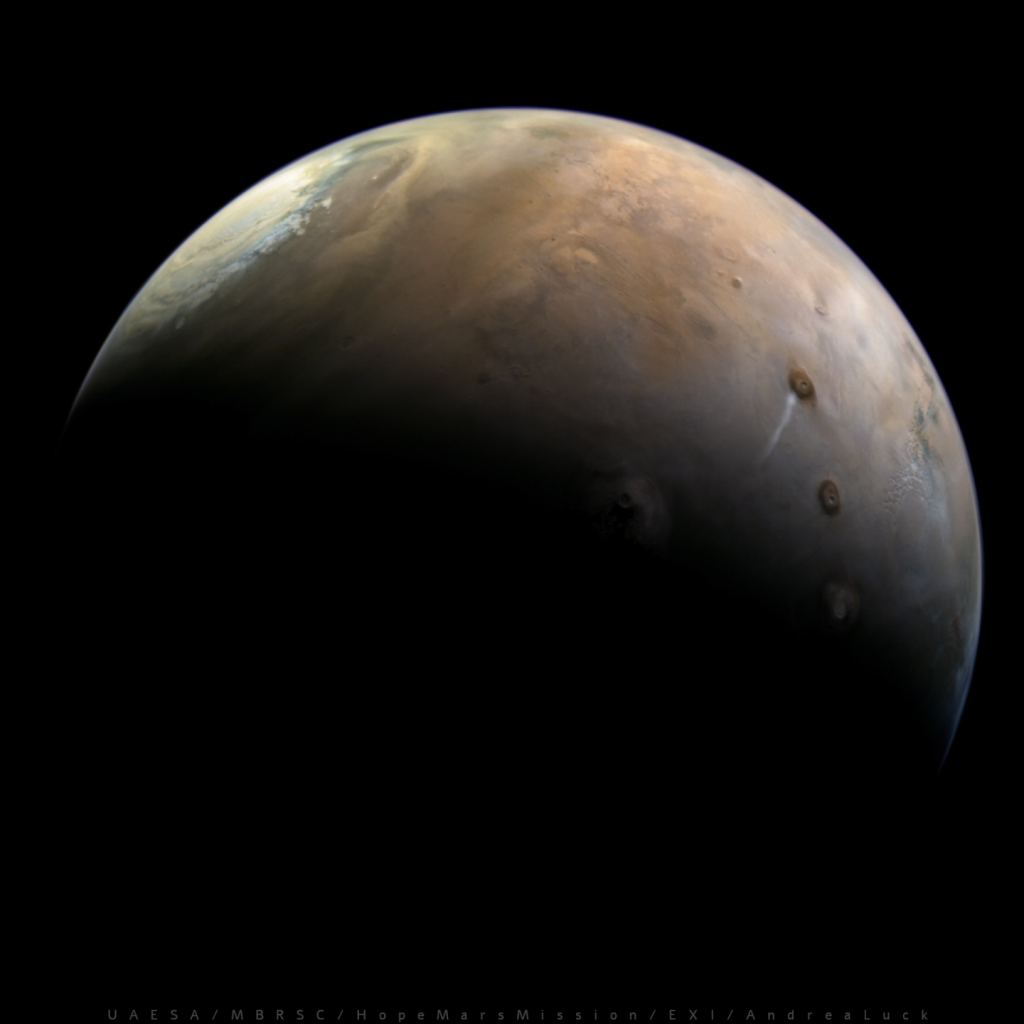 In this image a crescent Mars from the perspective of the spacecraft. On the top right side, the North Polar Cap appears icy and dusty. What's cool about this image is the elongated (orographic) cloud near Ascraeus Mons. It's also nice to see the enormous Olympus and Arsia Mons along the Terminator. The surface is a dusty red, as you would expect on Mars.