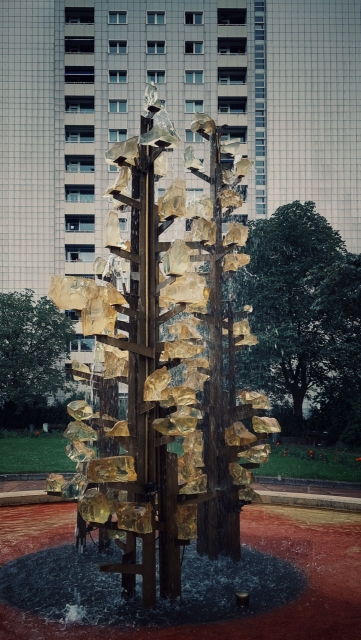 An East Modernist fountain in front of a facade from the same epoch.