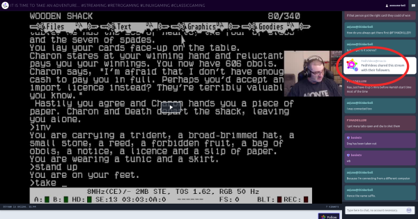 Screenshot of an OwnCast stream, with a main window filled with a retro text game and a camera view of the streamer themselves. In a side bar on the right is a chat window, and highlighted in the chat window is a message saying FediVideos shared this stream with their followers.