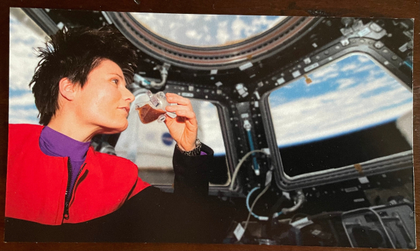 Astonaut Samantha Cristoforetti drinking from the space cup in the International Space Station 