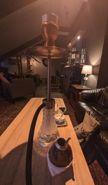 View of a tea lounge interior with a shisha standing on a table