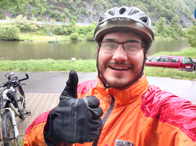 My selfie, wet to the bone, standing next to my bike and the Vltava river.