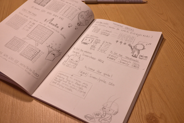 Open notebook pages showing sprite encoding and code for drawing sprites along side a couple of sketches of uxn and varvara.