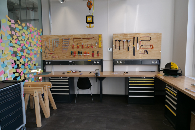the workshop of studio context, run by Franziska Polka. 
A workbench in fron of a wooden wall with tools mounted.