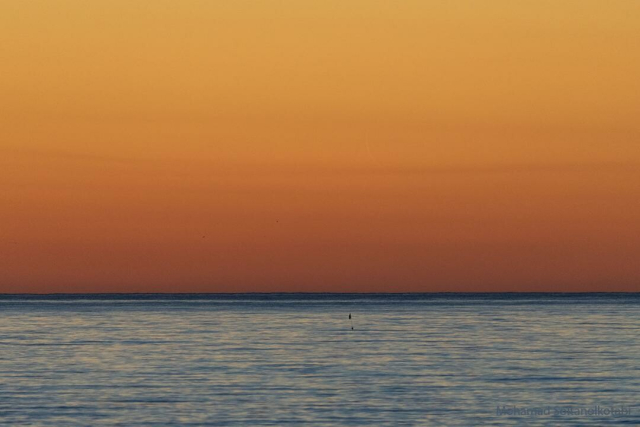 The featured image shows an orange sky over water with a very faint, slight crescent Moon in the sky.