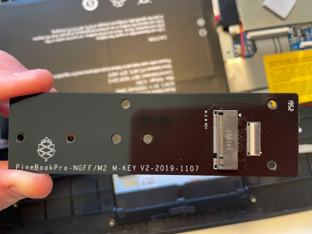 Photo of said device: a long, thin board with a place to plug in an NVMe drive.