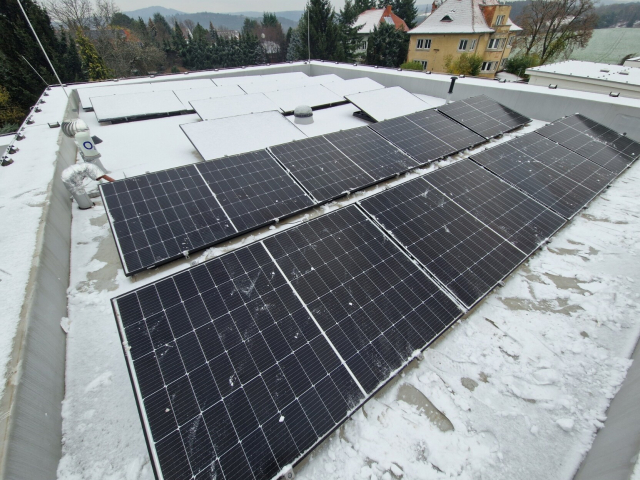 Solar panels on the roof partly cleared from snow.