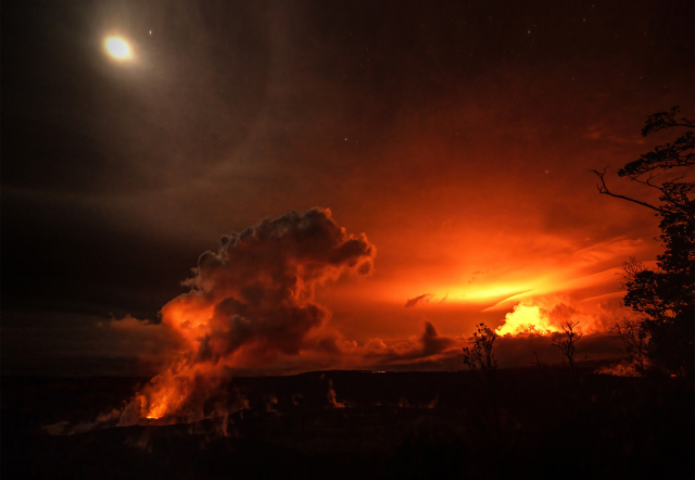 Nighttime photo of the simultaneous eruptions of Mauna Loa and Kilauea in Hawaii, with the Moon overhead.