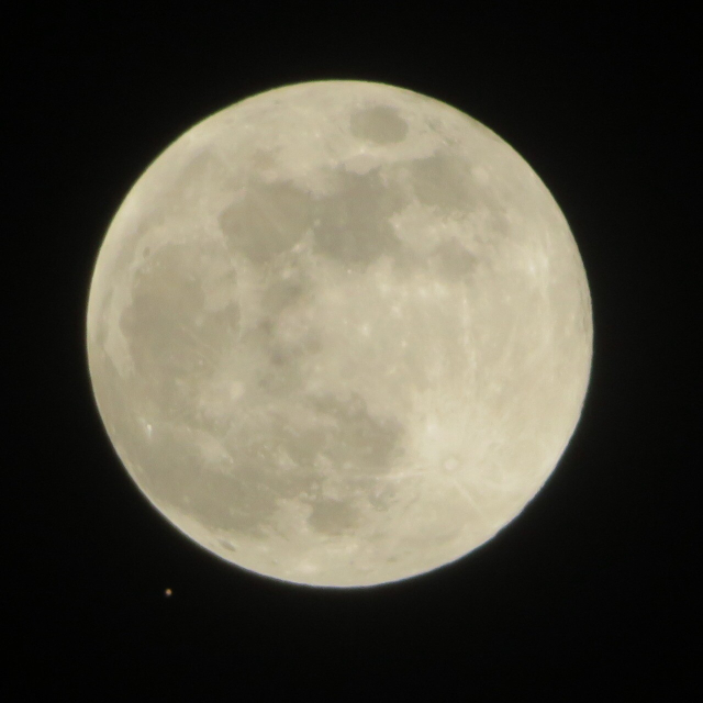 The full moon. To its lower left is a tiny red dot; that’s Mars.