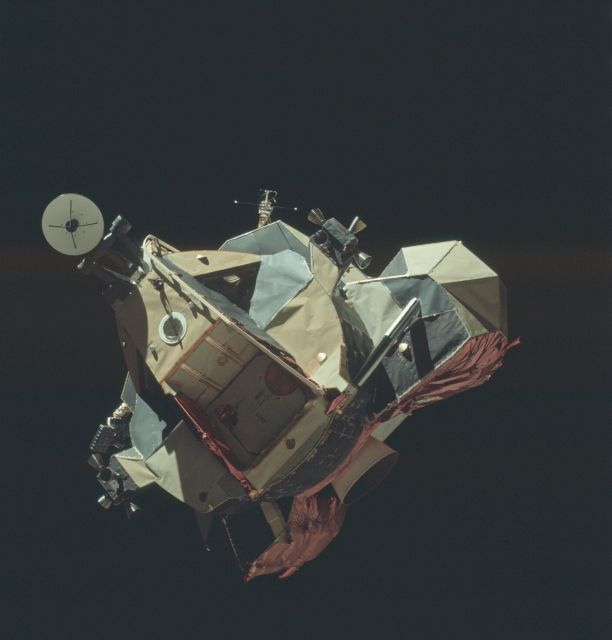 Color photo of the lunar lander returning to the orbiter above the Moon's surface. 