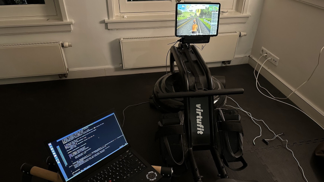 rower with an ipad showing a bike next to a laptop