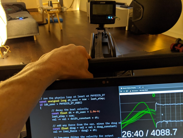 first person view of a rower with a laptop showing physics model code and charts of pull strength