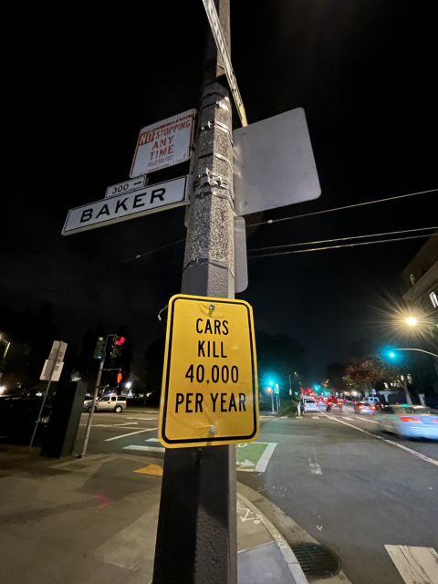 A street sign that says “cars kill 40,000 per year”