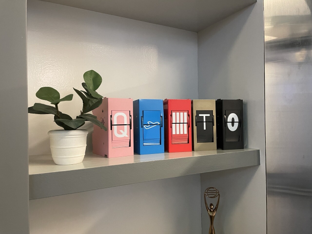 An assortment of split flap modules in different colors, with panels featuring an array of typefaces 