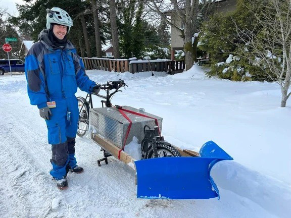 Photo of man with bike converted to snow plow