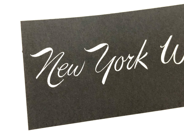 A sample of some script lettering by J. Albert Cavanaugh, reading 'New York' in a hand drawn connecting brush script. 