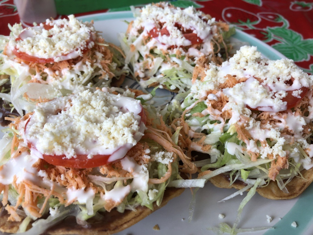 Four unreasonably good chicken tostadas on a plate.