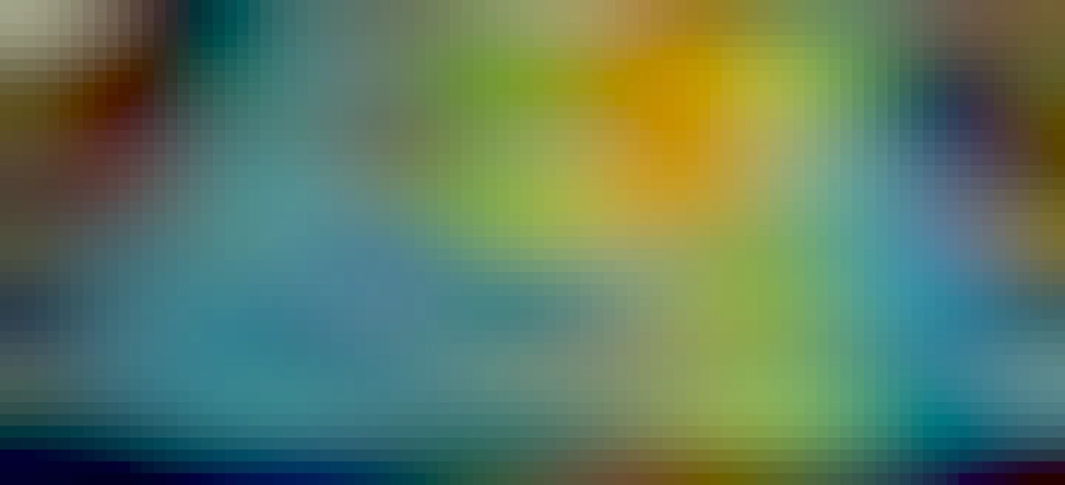 A multi-coloured striped blanket on a bed, with various bits of furniture in the background. The colours of the blanket represent the high and low temperatures experienced in Aberystwyth in 2022.  