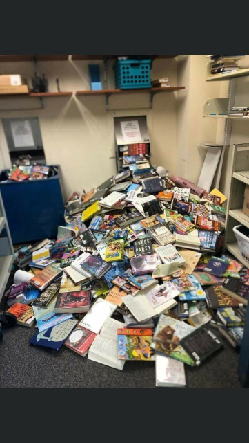 Backroom of a library. Hundreds of library books have been returned via the drop slot. So are skipping out all out all over the floor.