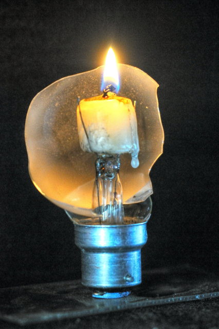 Broken bulb with a candle inside