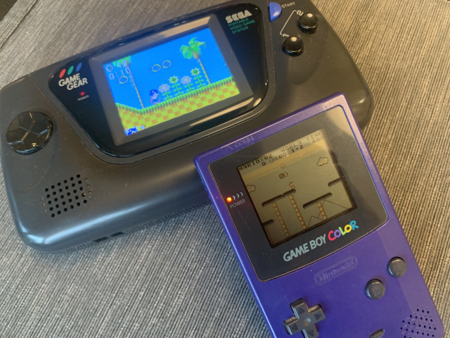 Black Sega GameGear running Sonic, and purple GameBoy Color running Super Mario World. 