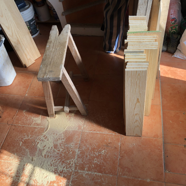 Las tablas cortadas y un montoncito de aserrín del serrucho.