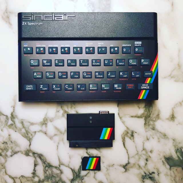 Sinclair ZX Spectrum with rainbow stripe across bottom right corner of the computer