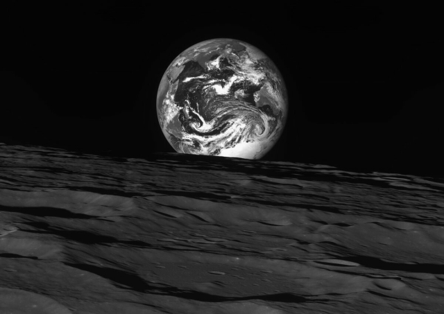 Fully lit Earth rising over the horizon of the shadowed Moon, imaged by South Korea's Danuri spacecraft. 