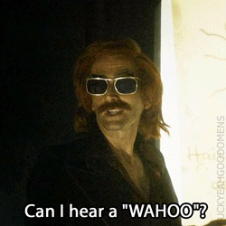 David Tennant, as the demon AJ Crowley in Good Omens, dressed in 1970s style with a ridiculous moustache, is presenting his plan for the M25 motorway. He asks his audience, “Can I hear a ‘wahoo’?”