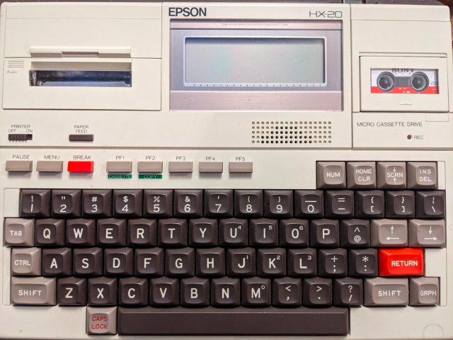 EPSON HX-20 portable computer, a small keyboard with tiny screen inset, a built-in printer and microcassette drive
