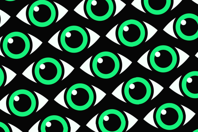 green eyes with a white glint on a patterned black background
