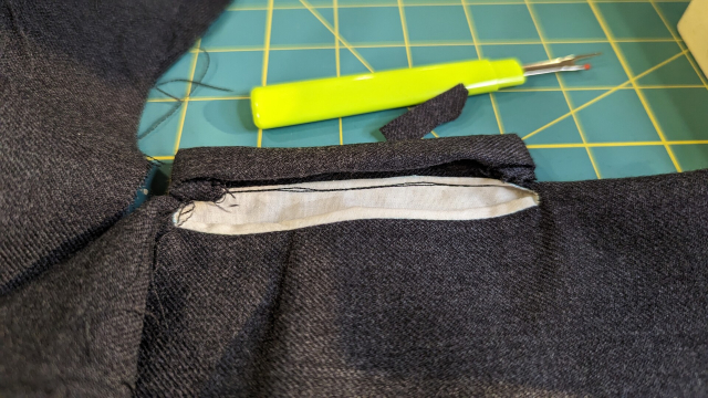 The inside of a pocket welt, with two lines of stitching (because I brain farted and cut the threads before tying them off the first time)