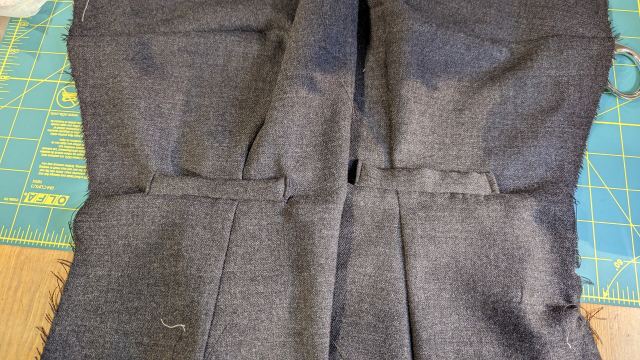 Two single welt pockets on the fronts of two front waistcoat panels 