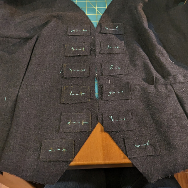 Buttonhole linings tacked into the "right side" (outside) of the left front and left front lining pieces of a waistcoat in progress