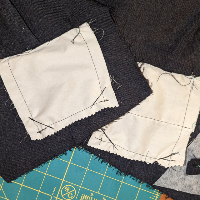 Lines of black stitching across the bottom corners of the white pockets. The bottom edges have a jagged cut to minimize raveling 
