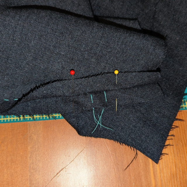 a shoulder seam, propped open with pins around a thread-traced dart, showing that the seam is pretty smooth.