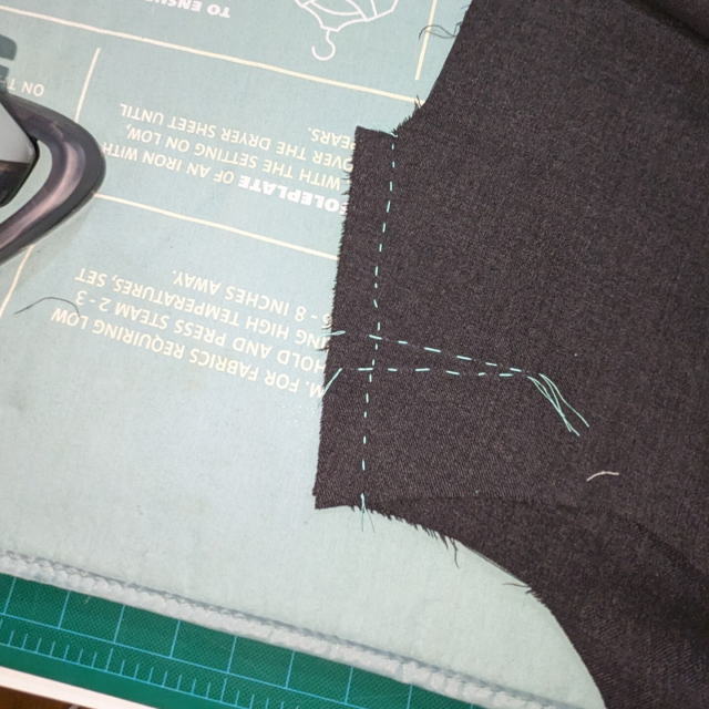 The back of the basted seam, ironed flat.