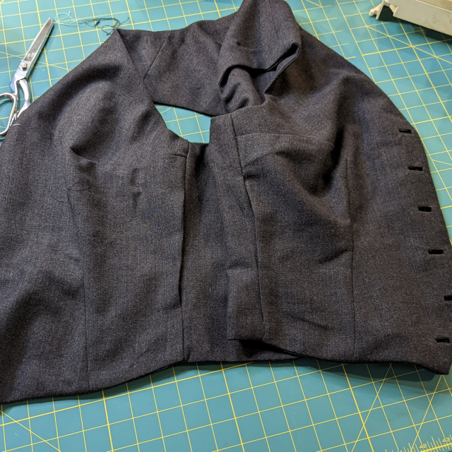 The side seams of the lining of an almost finished waistcoat. There's a gap on each side that will need to be stitched closed by hand.