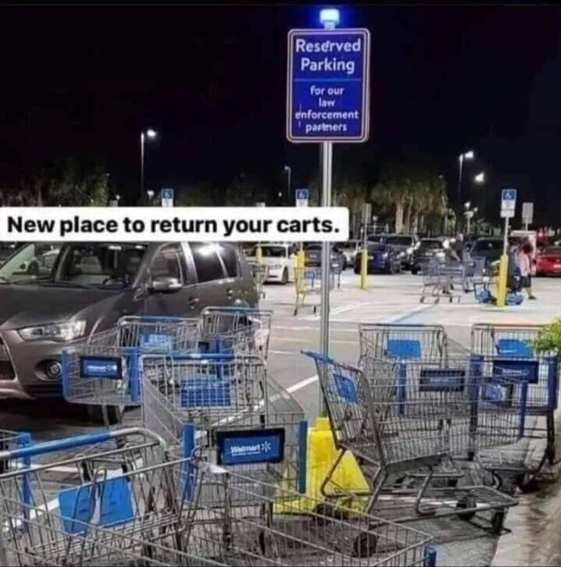 Seven or eight Walmart shopping carts placed haphazardly in a parking space with a sign reading "reserved parking for our law enforcement partners." The caption says "New place to return your carts."