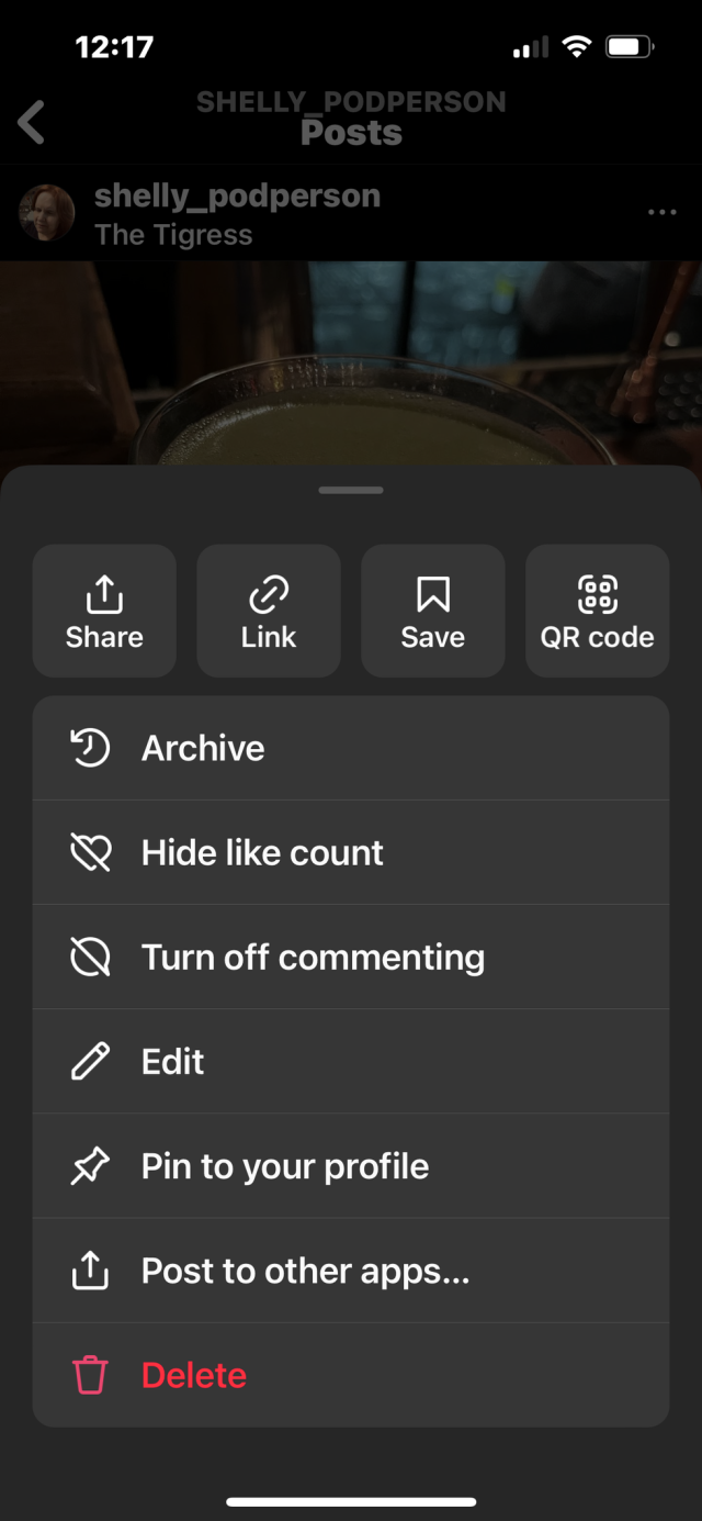 An Instagram app menu shows several options. The last one, label delete, is very low in color contrast with the background. The screenshot is taken with iOS dark mode on.