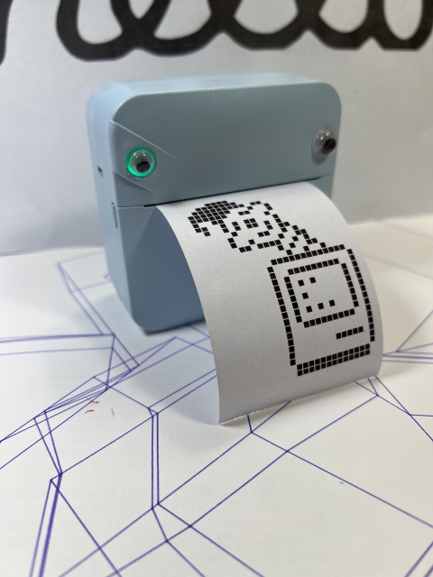 A small handheld thermal wireless printer in light blue with paper printed that has the pixelated icon of ResEdit on it. 