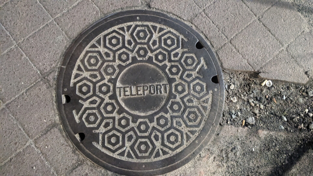 Manhole cover with the word "teleport" engraved 