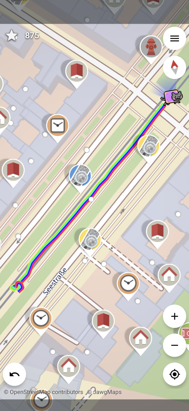 Screenshot of StreetComplete but the location indicator has been replaced by a Nyan cat and the location trail is a wide rainbow.