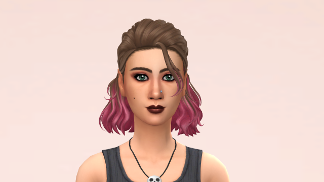 Close up of a woman with brown hair (with pink highlights), green eyes, a mole on her right cheek, and a nose piercing. She is wearing a black tank top and a necklace with a skull on it.