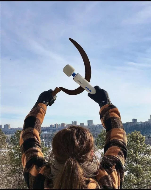 Woman holding up a hammer and sickle. Only the hammer is a hitachi magic wand.