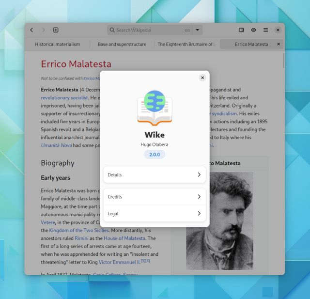 Screenshot of Wike at a desktop size, with multiple open tabs, and the About dialog above the main window. The About dialog shows a new icon, consisting of an orange book with a planet floating above it.