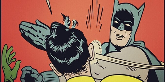 Batman slaps Robin in the face.