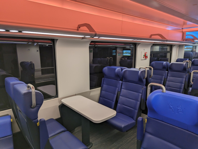 A group of four seats with almost no window view.
