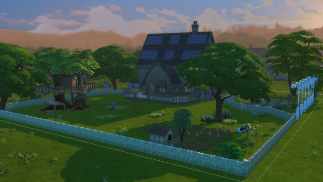 A three-story thatched english cottage in the sims, viewed from the back.