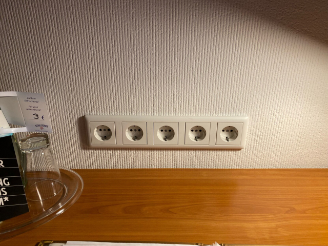Five (!) schuko power outlets atop a desk.